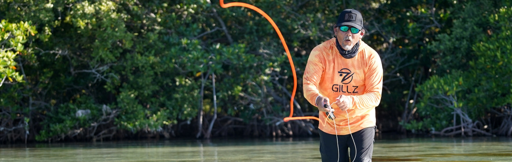 Man In Orange Shirt Fishing